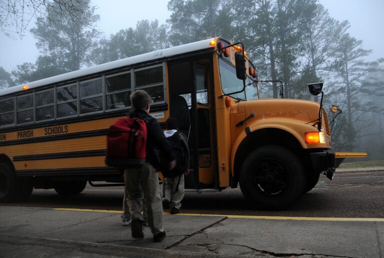 Children boarding a yellow school bus