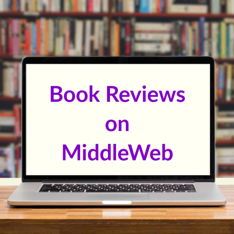 Laptop computer on wooden table with screen that says book Reviews on MiddleWeb, and blurred background of books on shelves.